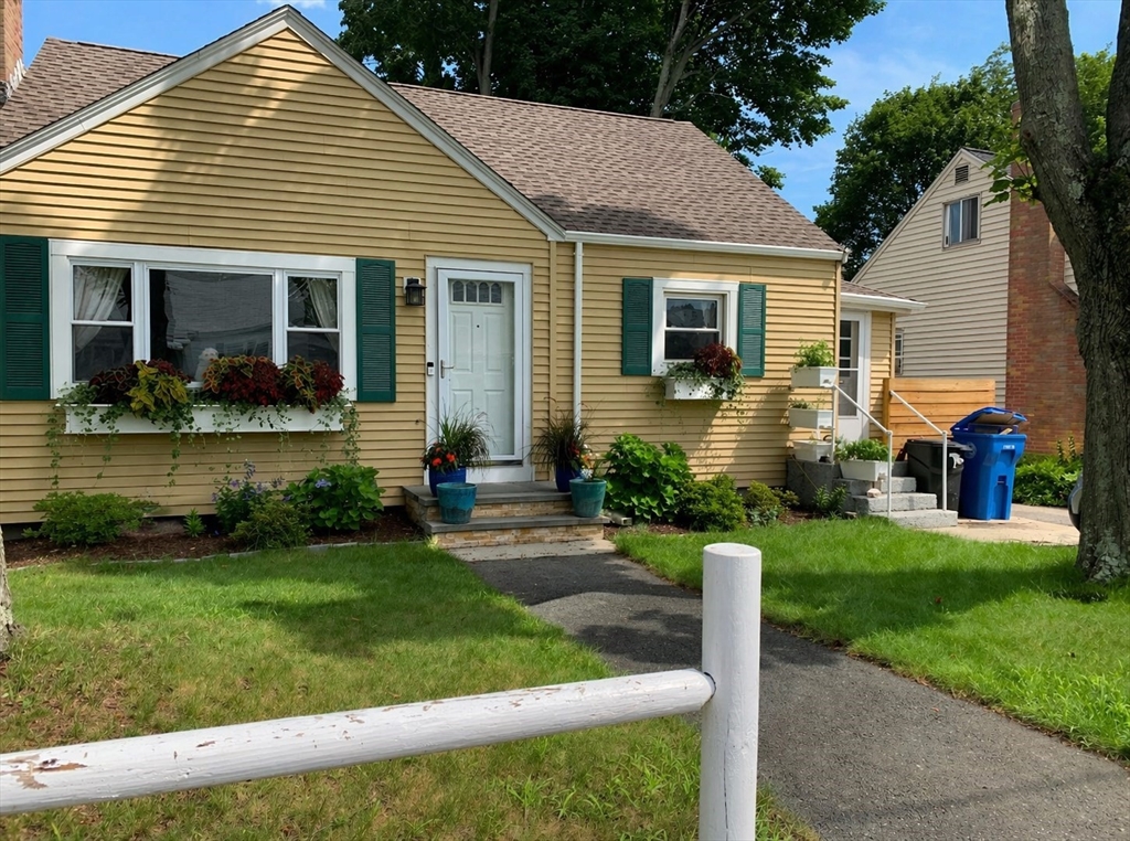 a front view of a house with a yard and porch