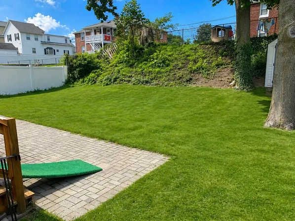 a view of a house with a backyard