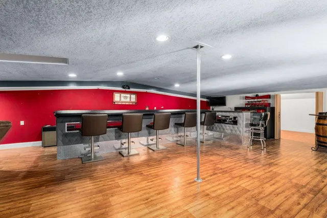 a house with green field in front of it