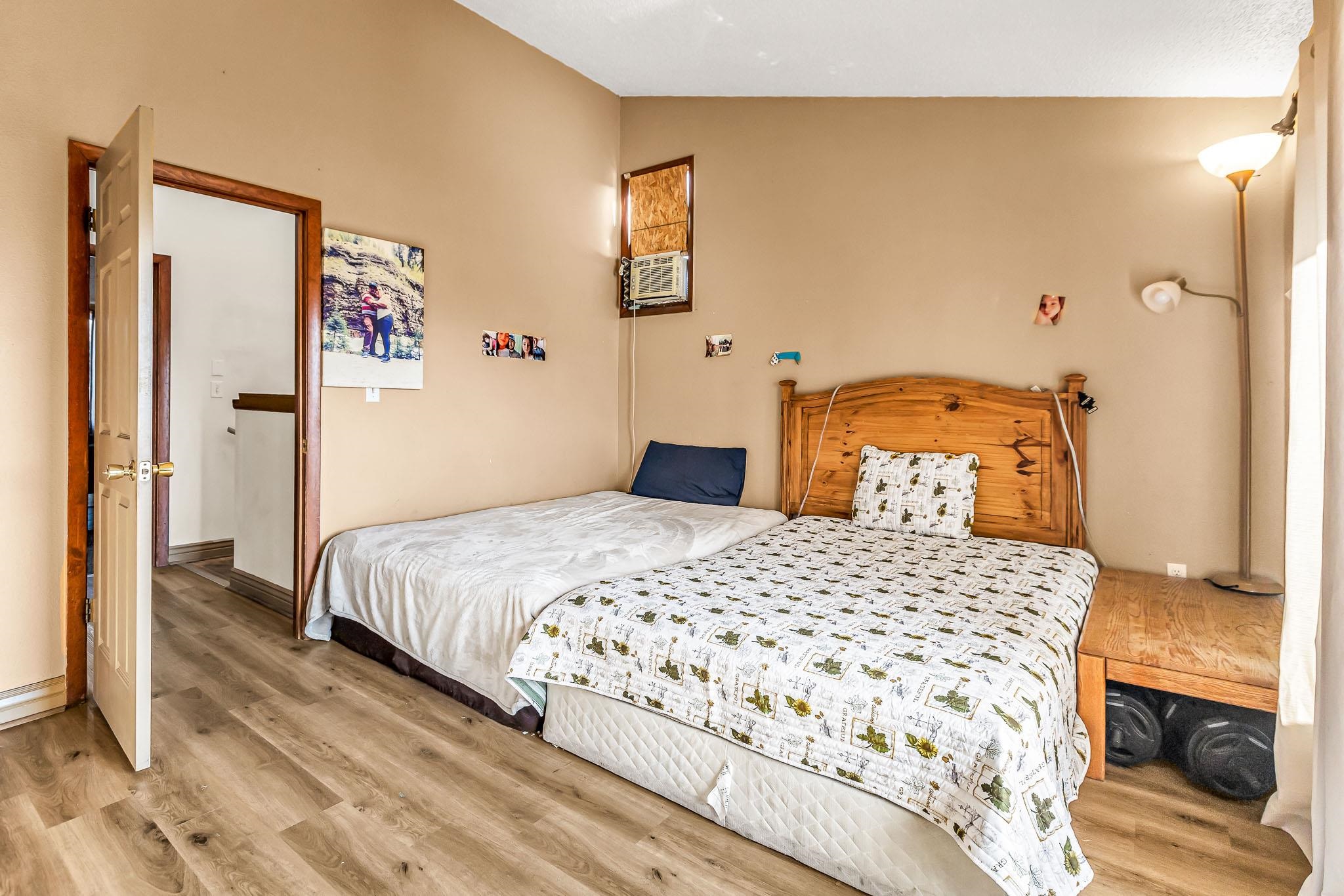 759 Elder Court Rifle, CO 81650 - Photo 12 of 26 a bedroom with a bed and wooden floor