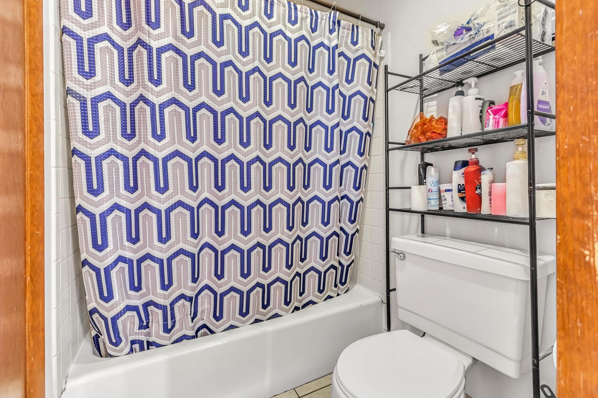 759 Elder Court Rifle, CO 81650 - Photo 14 of 26 a bathroom with a toilet and a shower curtain