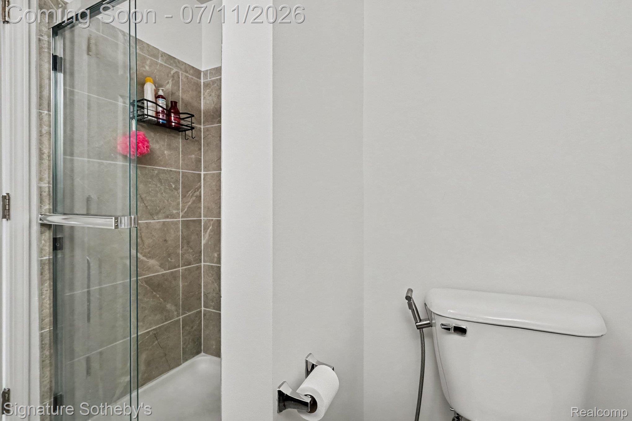 2500 Normandy Road, Unit 40 Royal Oak, MI 48073 - Photo 22 of 26 Shower with glass enclosure and neutral-toned wall tiling