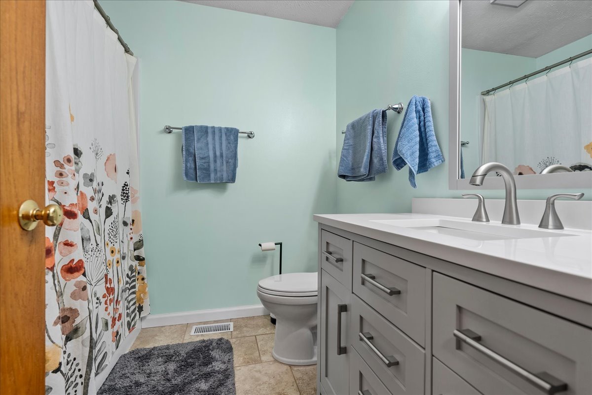 1421 Godfrey Drive Normal, IL 61761 - Photo 17 of 28 a bathroom with a sink toilet and shower