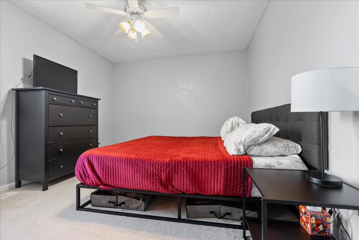 1421 Godfrey Drive Normal, IL 61761 - Photo 18 of 28 a bedroom with a bed and a lamp on dresser