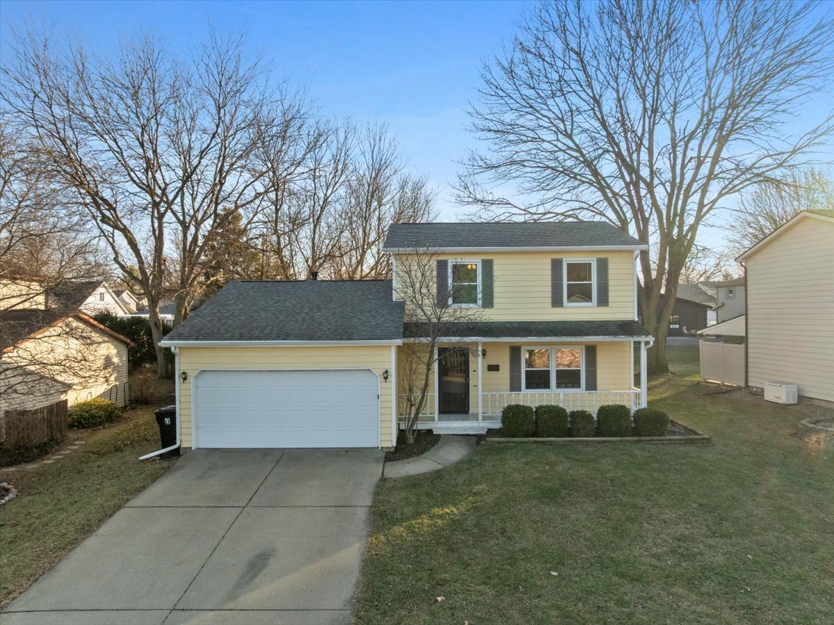 1421 Godfrey Drive Normal, IL 61761 - Photo 2 of 28 a front view of a house with a garden and trees