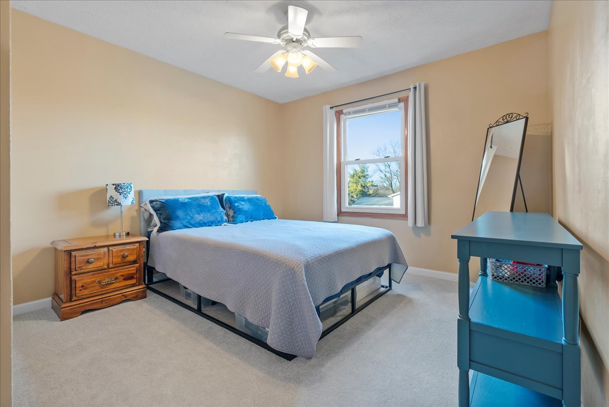 1421 Godfrey Drive Normal, IL 61761 - Photo 21 of 28 a bedroom with a bed and a chandelier