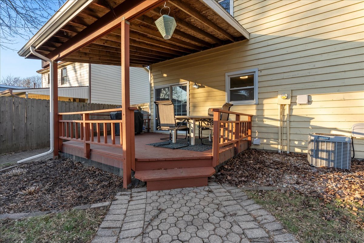1421 Godfrey Drive Normal, IL 61761 - Photo 24 of 28 a view of a patio with table and chairs and wooden floor