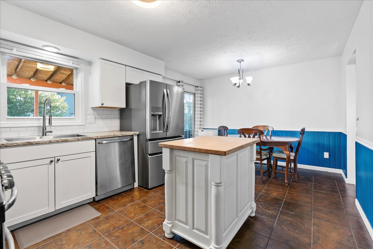 1421 Godfrey Drive Normal, IL 61761 - Photo 10 of 28 a kitchen with refrigerator and chairs