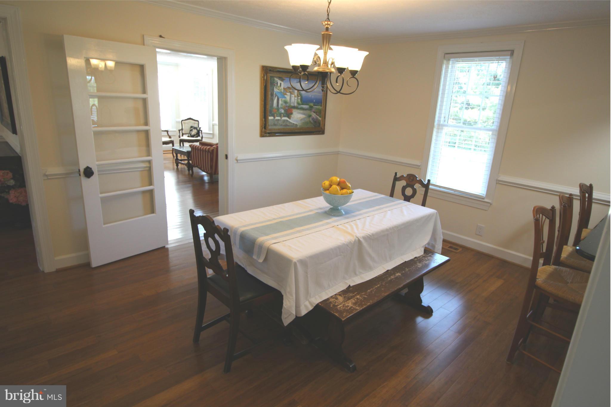 2280 Reliance Road Middletown, VA 22645 - Photo 11 of 28 a bedroom with a bed and a chandelier