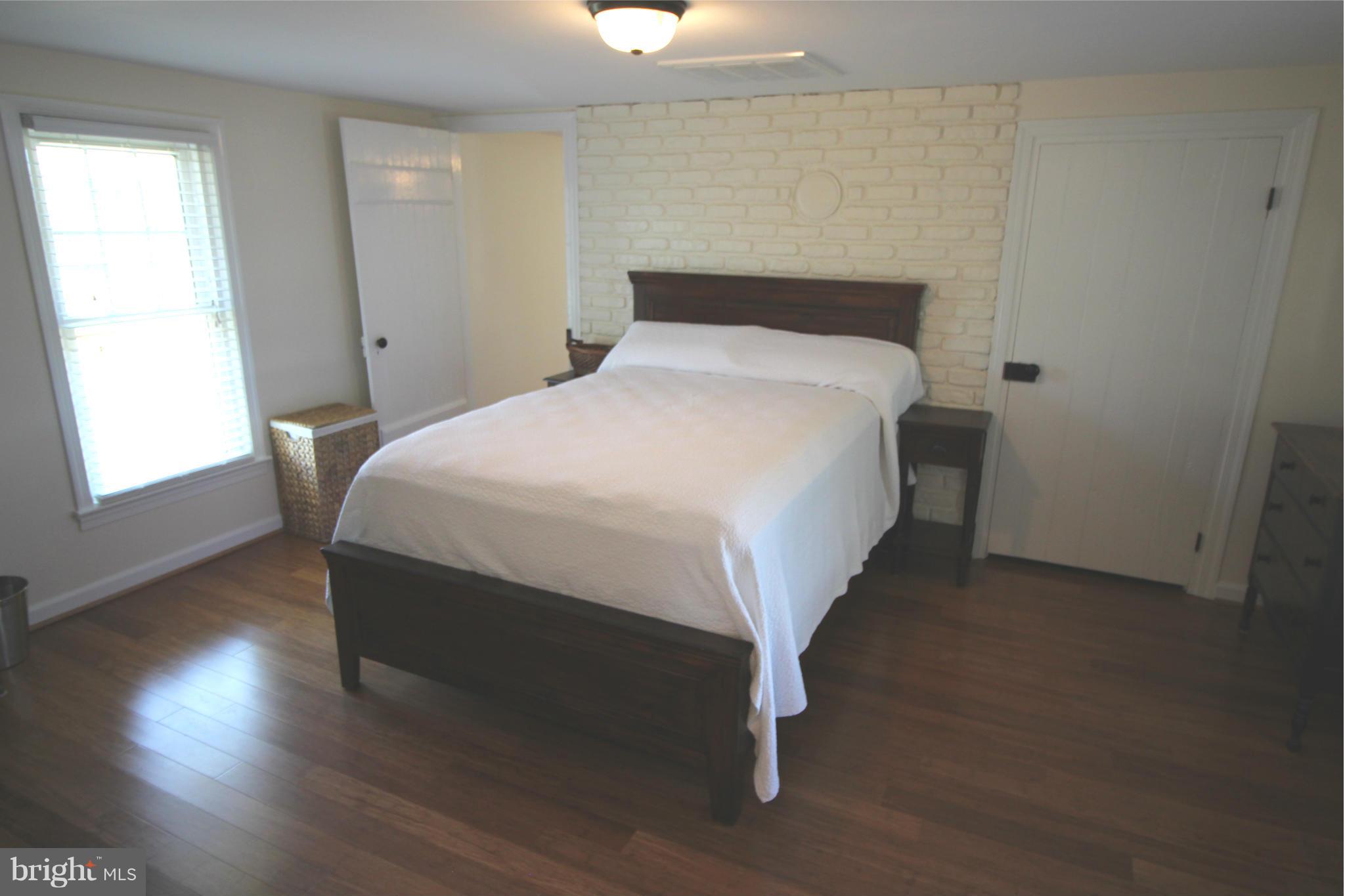 2280 Reliance Road Middletown, VA 22645 - Photo 18 of 28 a bed sitting in a bedroom next to a window