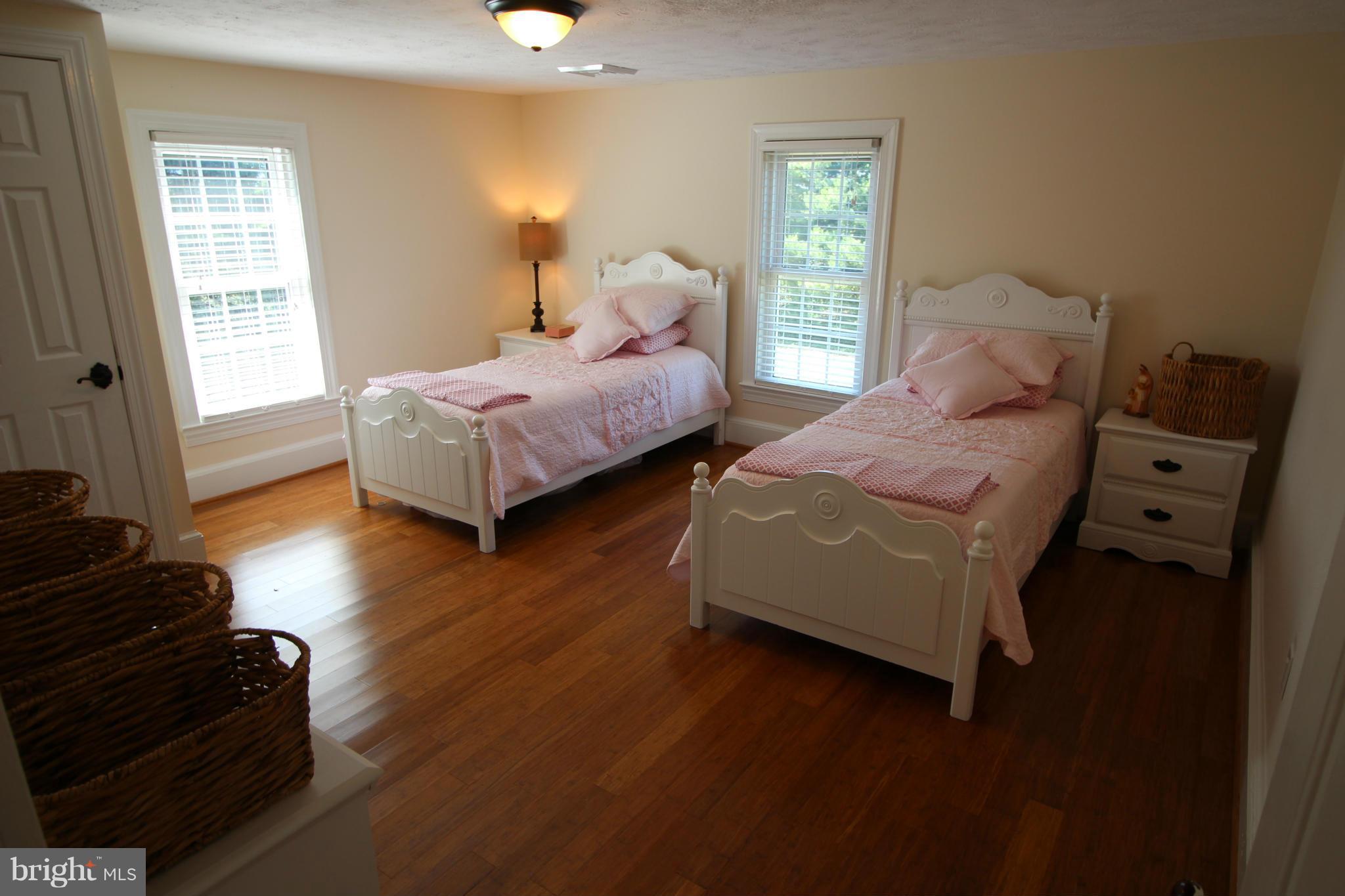 2280 Reliance Road Middletown, VA 22645 - Photo 19 of 28 a spacious bedroom with two beds and wooden floor