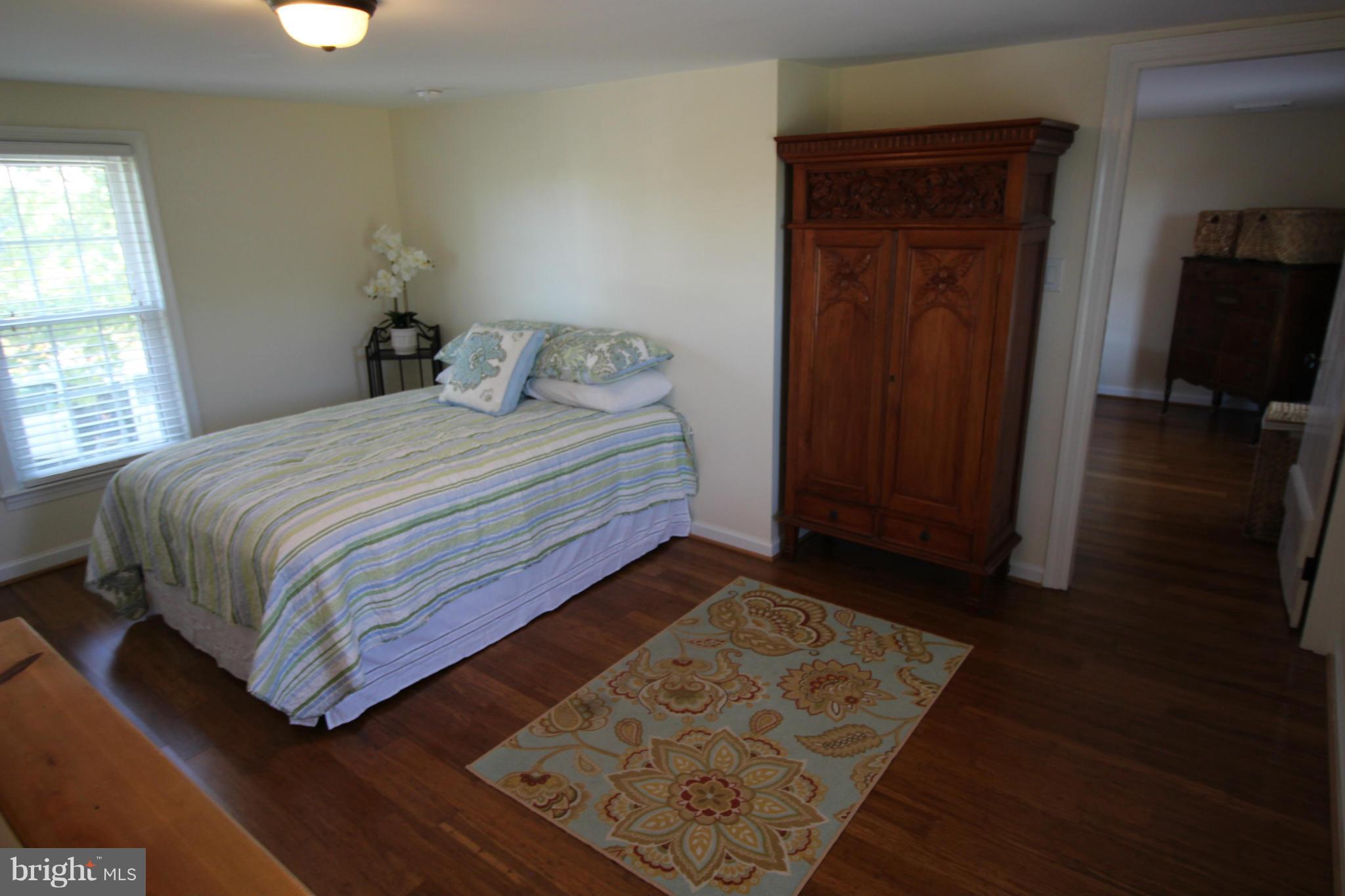 2280 Reliance Road Middletown, VA 22645 - Photo 22 of 28 a bedroom with a bed and wooden floor