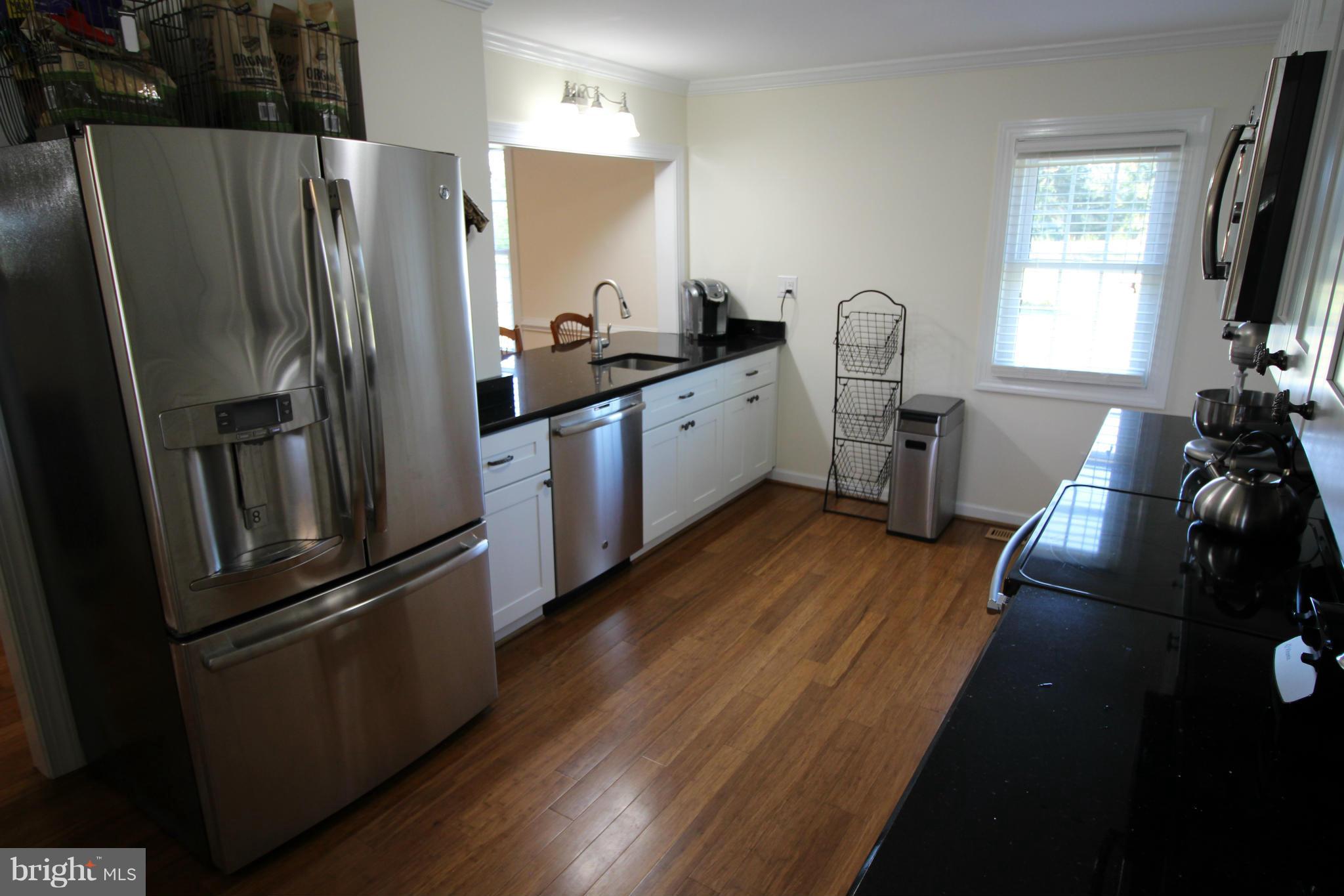 2280 Reliance Road Middletown, VA 22645 - Photo 8 of 28 a kitchen with stainless steel appliances a refrigerator a sink a stove and wooden floor