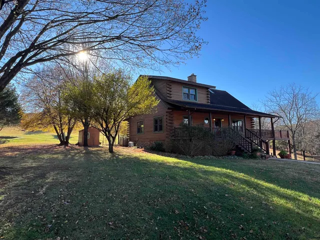 a view of dirt yard with large trees