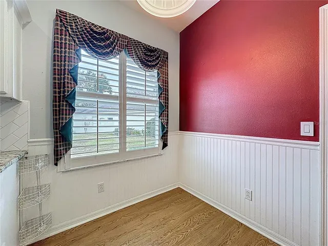 a spacious bathroom with a granite countertop sink a large mirror and a bathtub