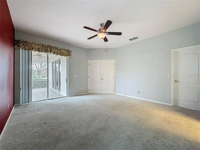 a bathroom with a granite countertop sink a toilet and a mirror