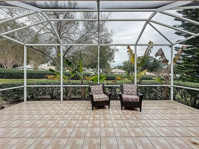 a front view of house with yard and trees around
