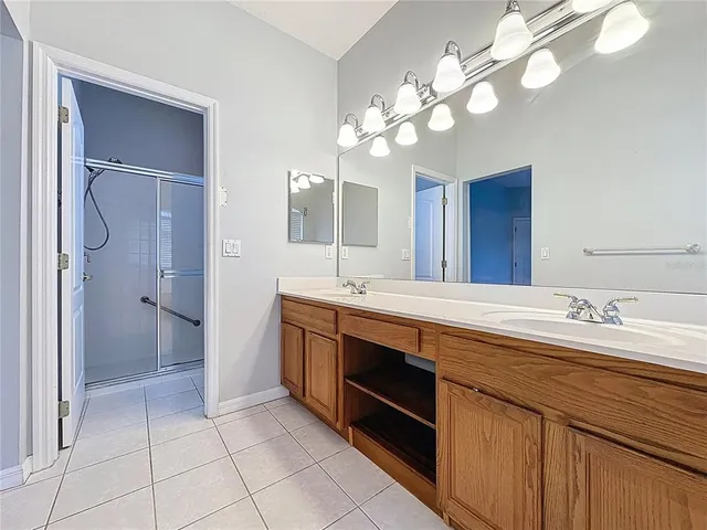 a view of a house with a yard and palm trees