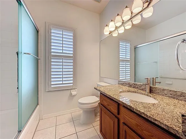 a view of a house with swimming pool and sitting area