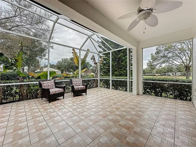 a living room with furniture and a book shelf