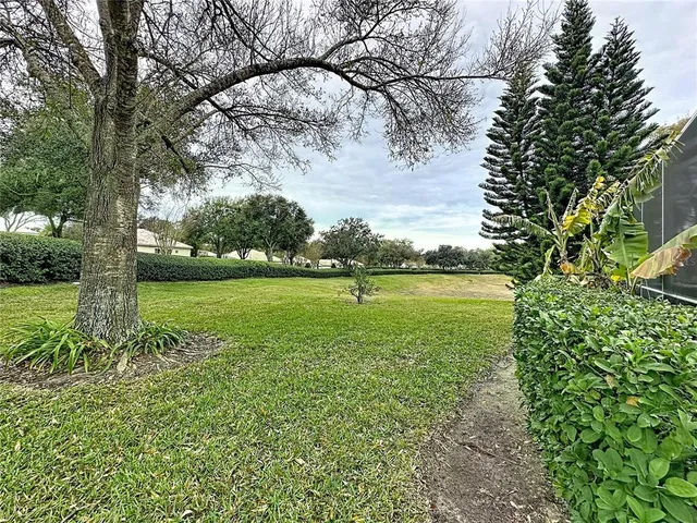 a kitchen with a table chairs refrigerator and cabinets