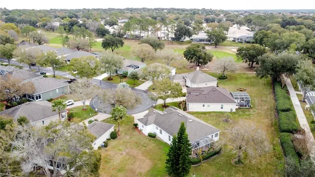 a view of a livingroom with a chandelier fan and windows
