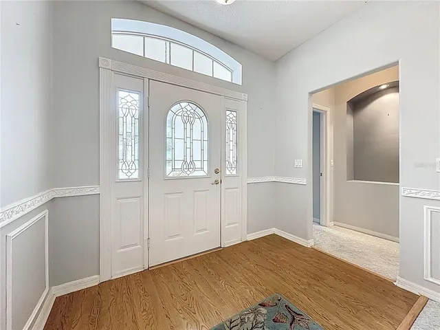 a room with granite countertop wooden floors and a window