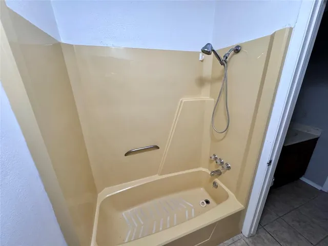a bathroom with a shower and a bath tub
