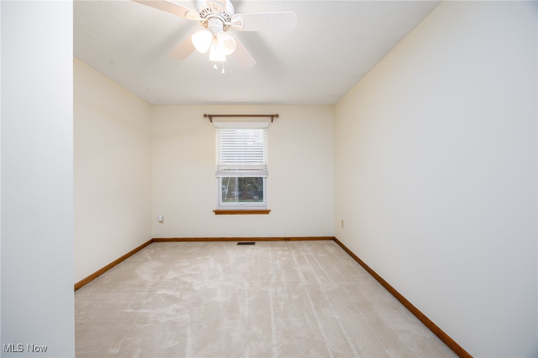 1838 Sandy Lake Road Ravenna, OH 44266 - Photo 37 of 41 Upper level bedroom with carpet, window with custom blind.