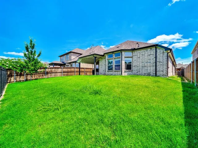 a view of a house with a yard and sitting area