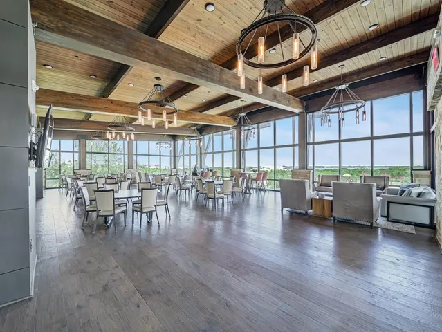 a dining room with furniture wooden floor and a floor to ceiling window