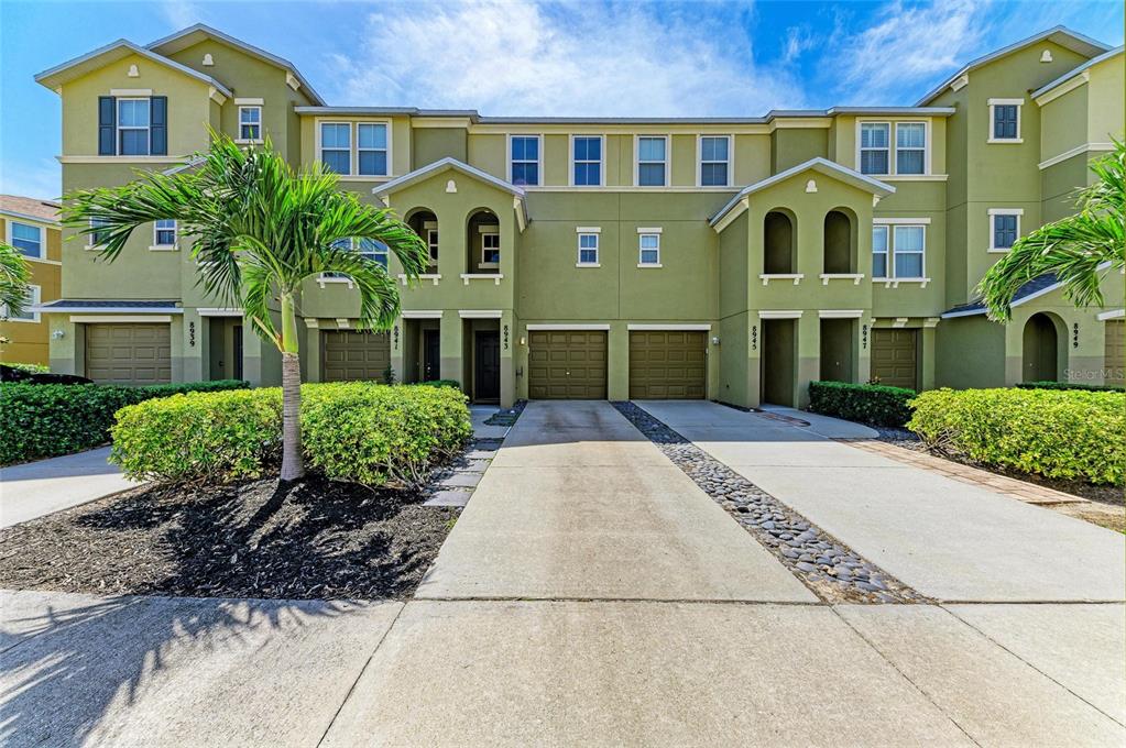 8943 White Sage Loop Lakewood Ranch, FL 34202 - Photo 1 of 1 front view of a brick house with a yard
