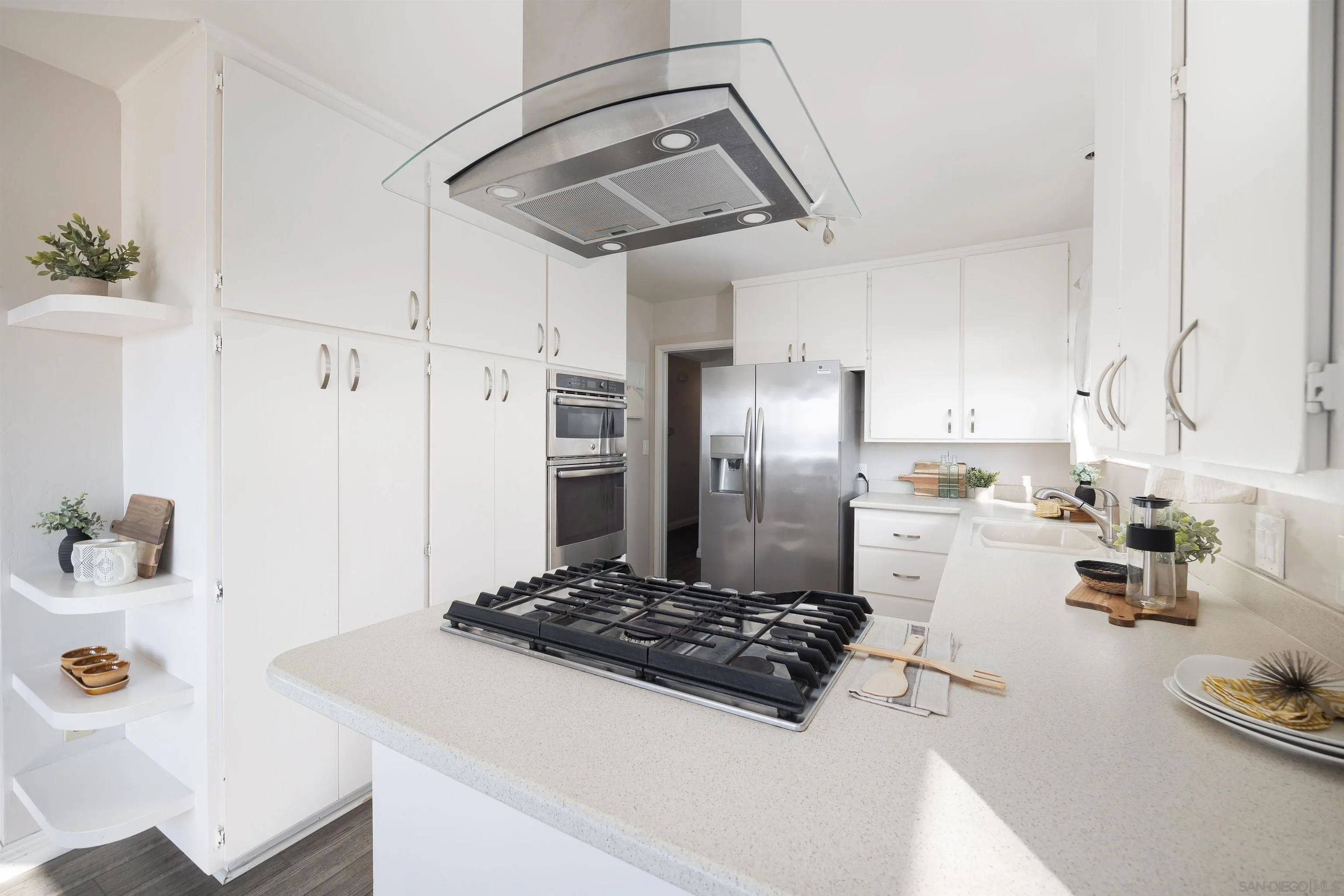444 Chesterfield Drive Cardiff, CA 92007 - Photo 13 of 29 a kitchen with a sink stainless steel appliances a refrigerator and cabinets