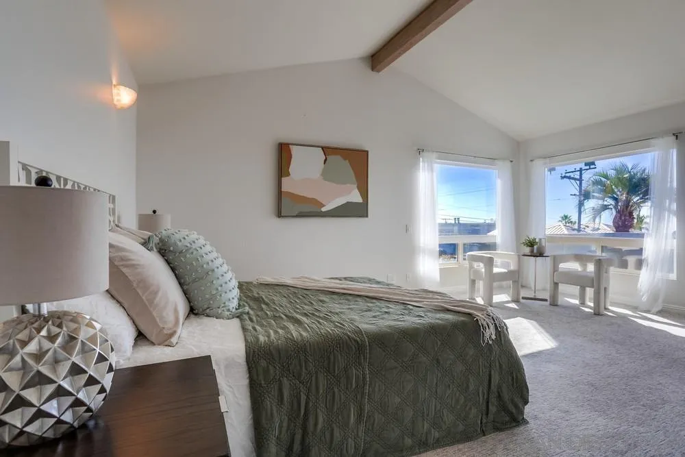 444 Chesterfield Drive Cardiff, CA 92007 - Photo 23 of 29 a bed sitting in a bedroom next to a window with chair and couch