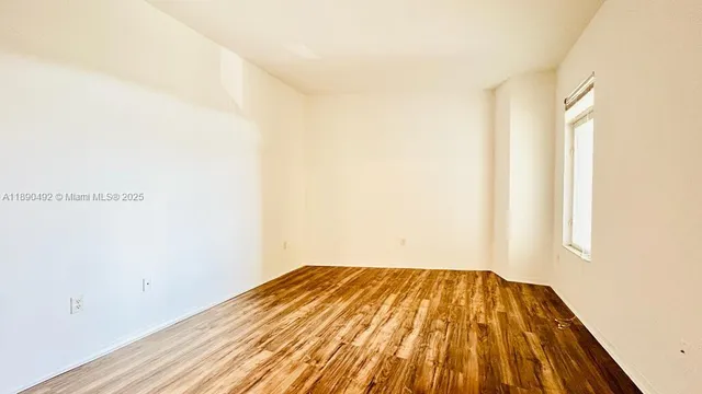 a view of a room with wooden floor