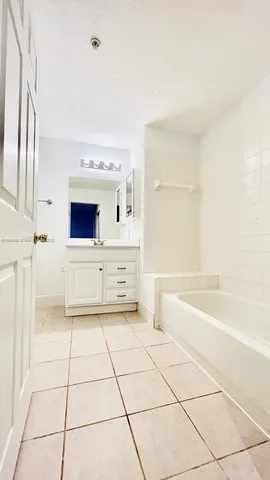 a bathroom with a bathtub and a sink