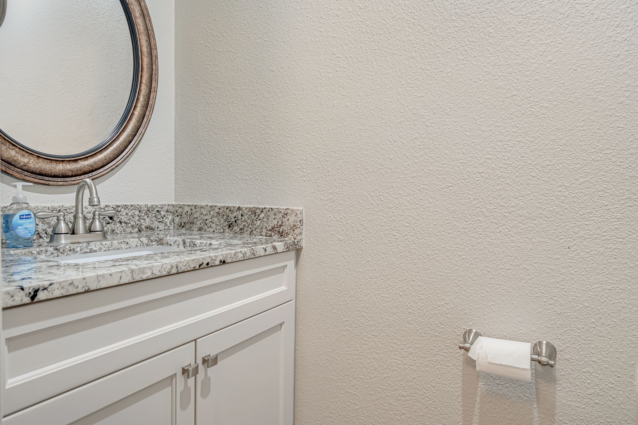4702 Spring Lane Baytown, TX 77521 - Photo 11 of 34 a bathroom with a granite countertop and mirror