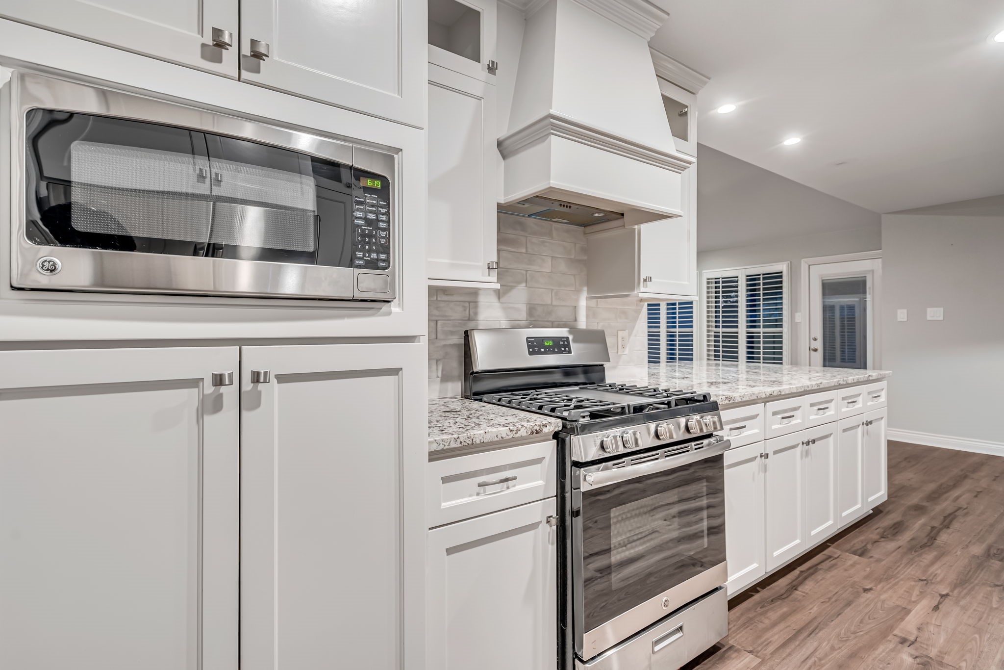 4702 Spring Lane Baytown, TX 77521 - Photo 14 of 34 a kitchen with stainless steel appliances granite countertop a stove and a microwave