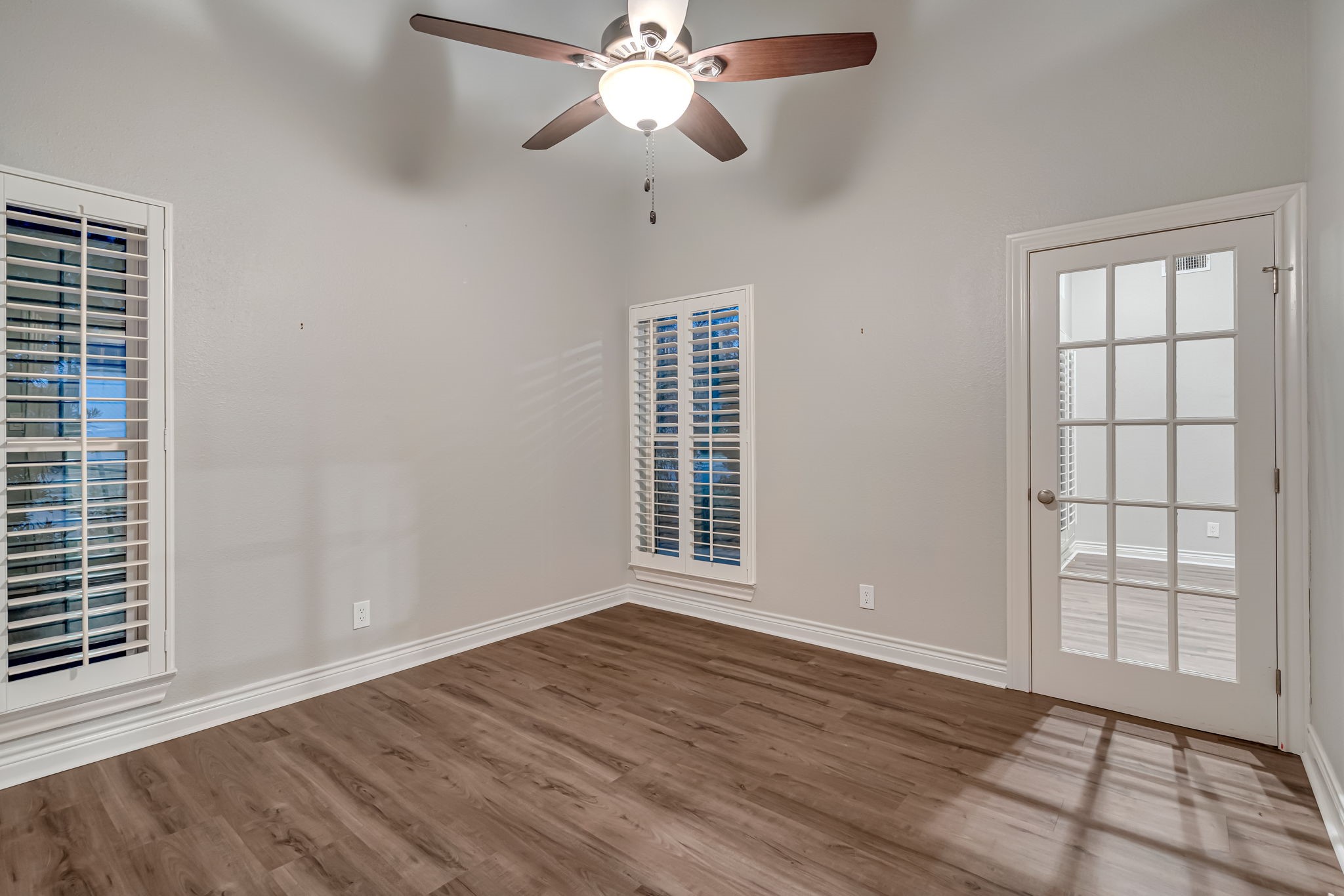 4702 Spring Lane Baytown, TX 77521 - Photo 15 of 34 a view of an empty room with wooden floor and a window