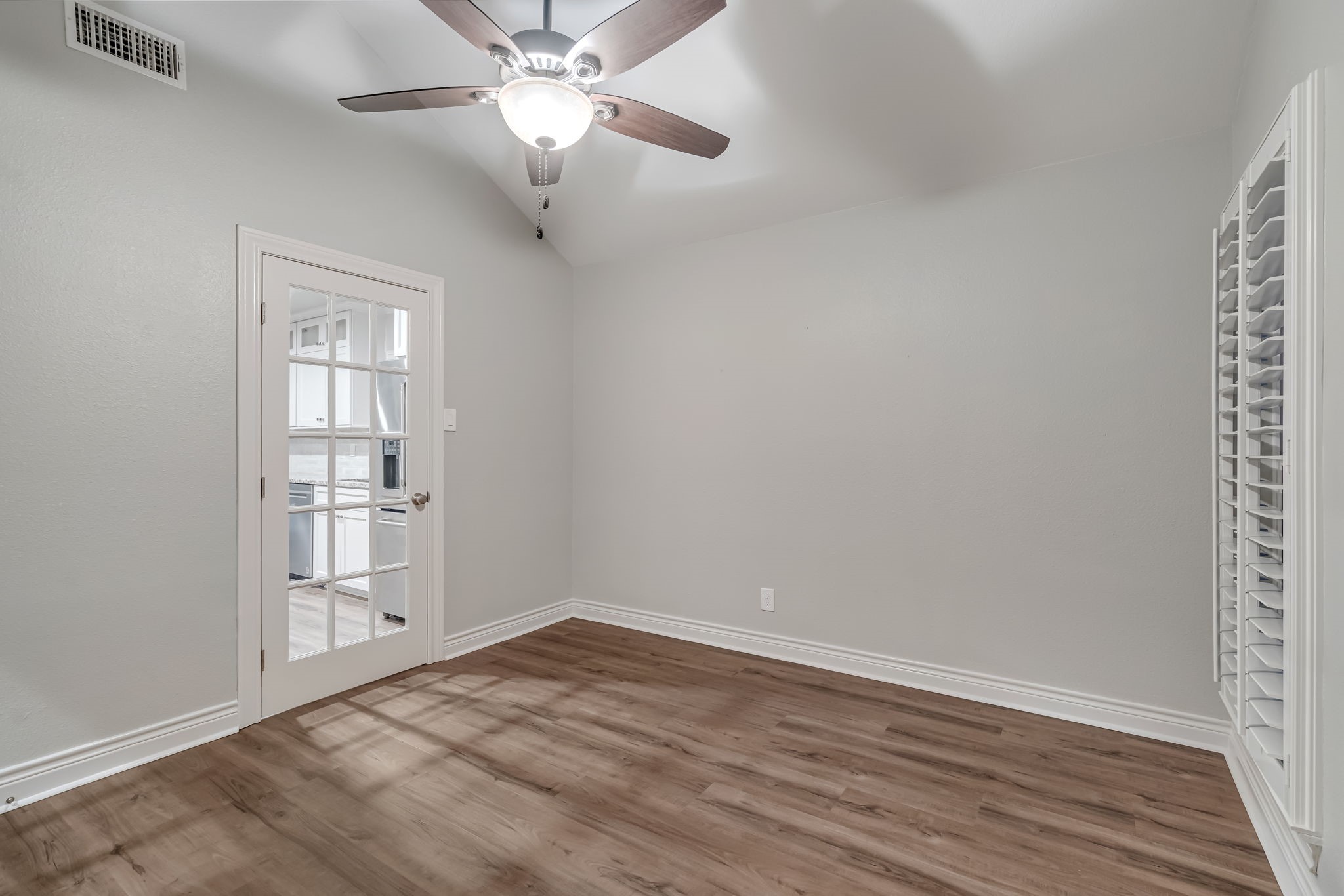 4702 Spring Lane Baytown, TX 77521 - Photo 16 of 34 wooden floor in an empty room with a window