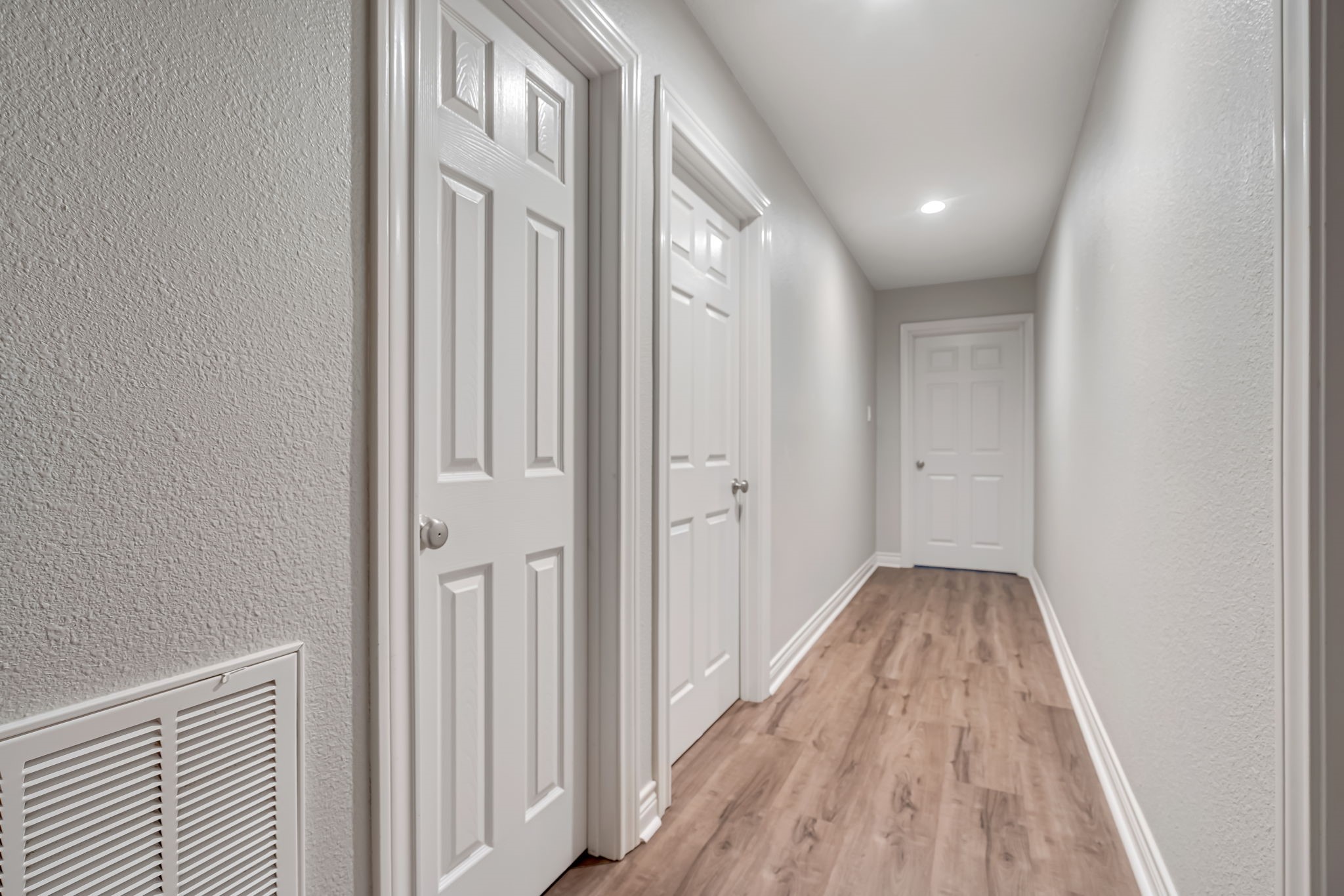 4702 Spring Lane Baytown, TX 77521 - Photo 29 of 34 a view of a hallway with wooden floor