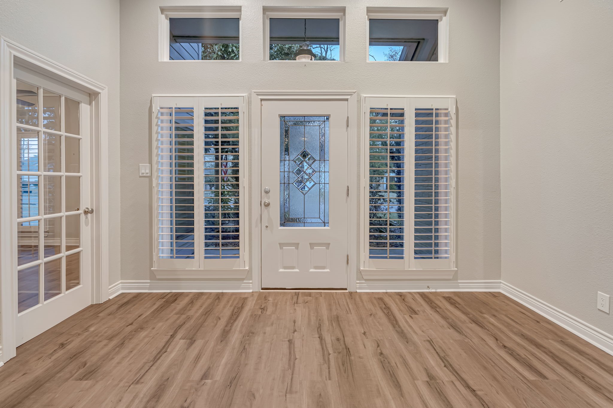 4702 Spring Lane Baytown, TX 77521 - Photo 3 of 34 front view of an empty room with wooden floor and windows