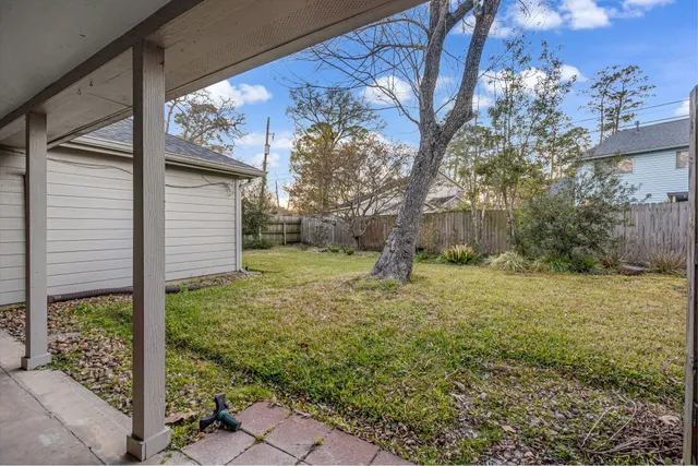 a view of a backyard with large trees