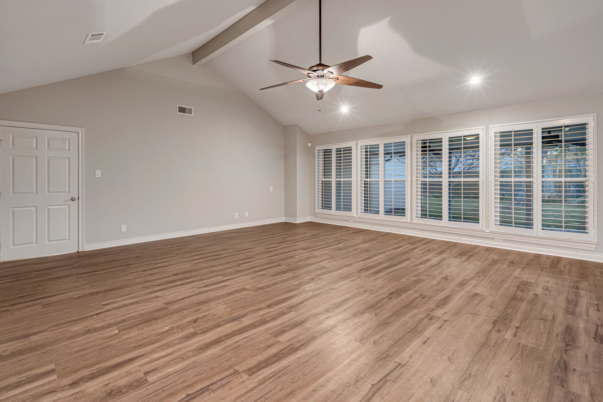 4702 Spring Lane Baytown, TX 77521 - Photo 4 of 34 a view of an empty room with wooden floor and a window
