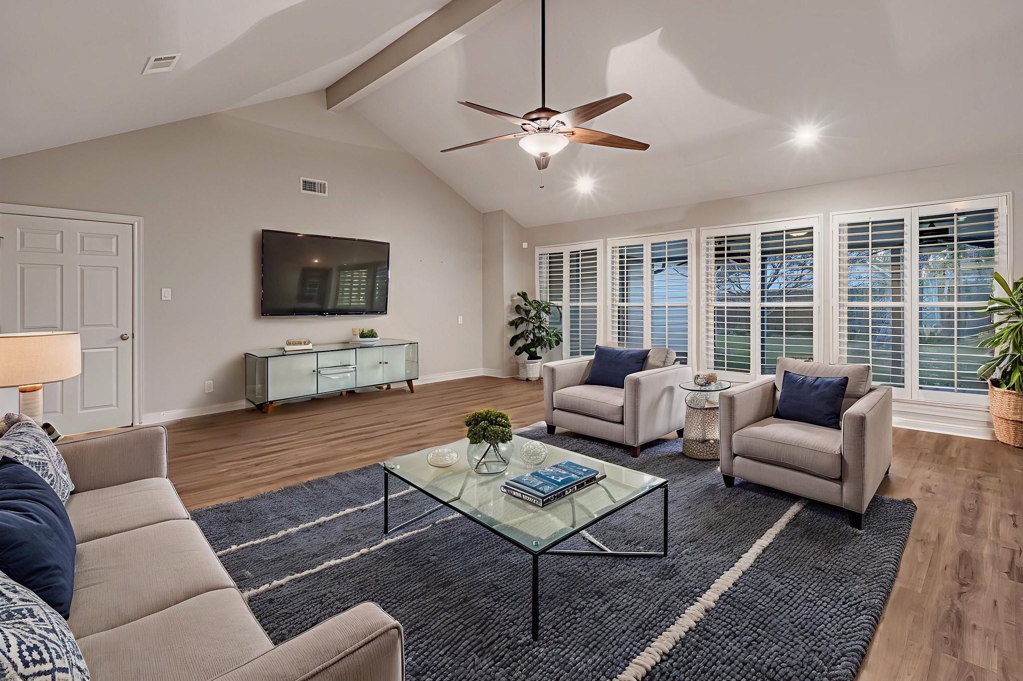 4702 Spring Lane Baytown, TX 77521 - Photo 5 of 34 a living room with furniture a large window and a flat screen tv