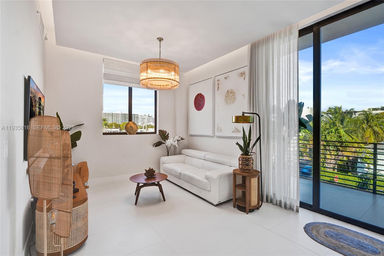 1030 15th Street, Unit PH5 Miami Beach, FL 33139 - Photo 11 of 38 a living room with furniture and a chandelier