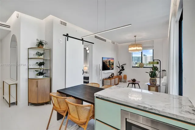 a kitchen with a table and refrigerator