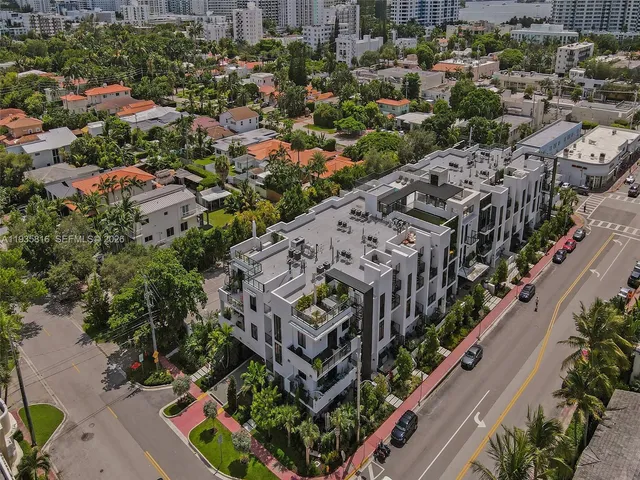 a city street lined with buildings and trees