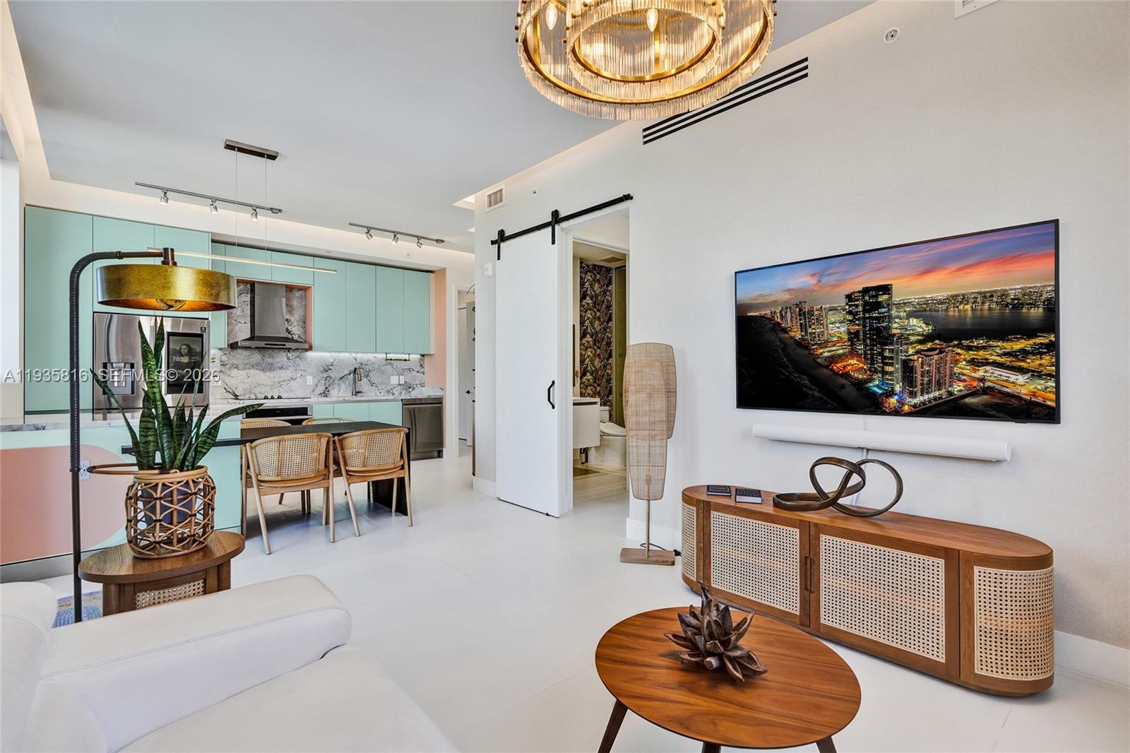 1030 15th Street, Unit PH5 Miami Beach, FL 33139 - Photo 5 of 38 a living room with furniture and a flat screen tv