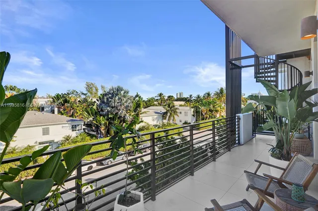 a view of a balcony with chairs